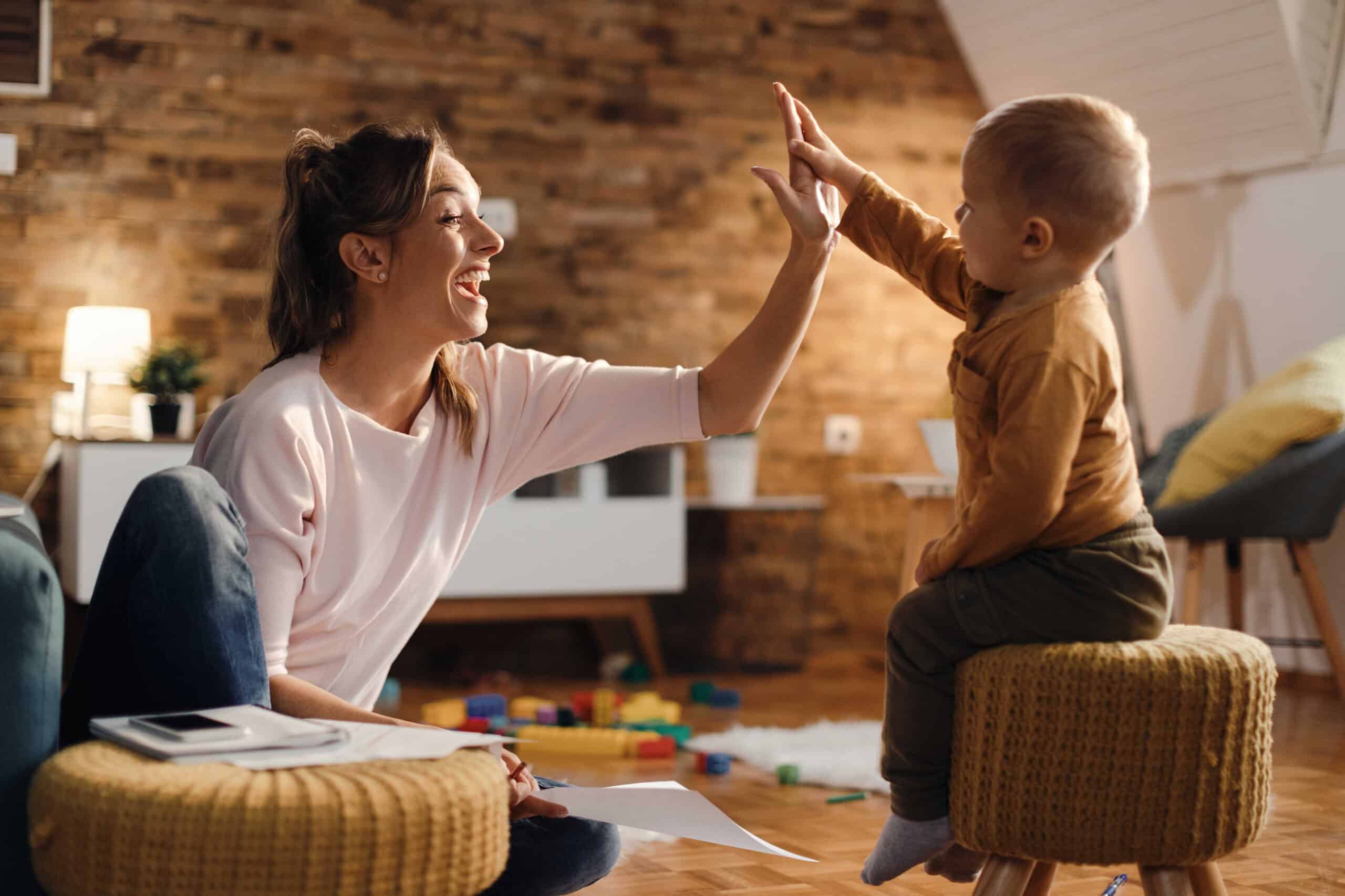 cheerful-mother-giving-highfive-her-small-son-home_optimized